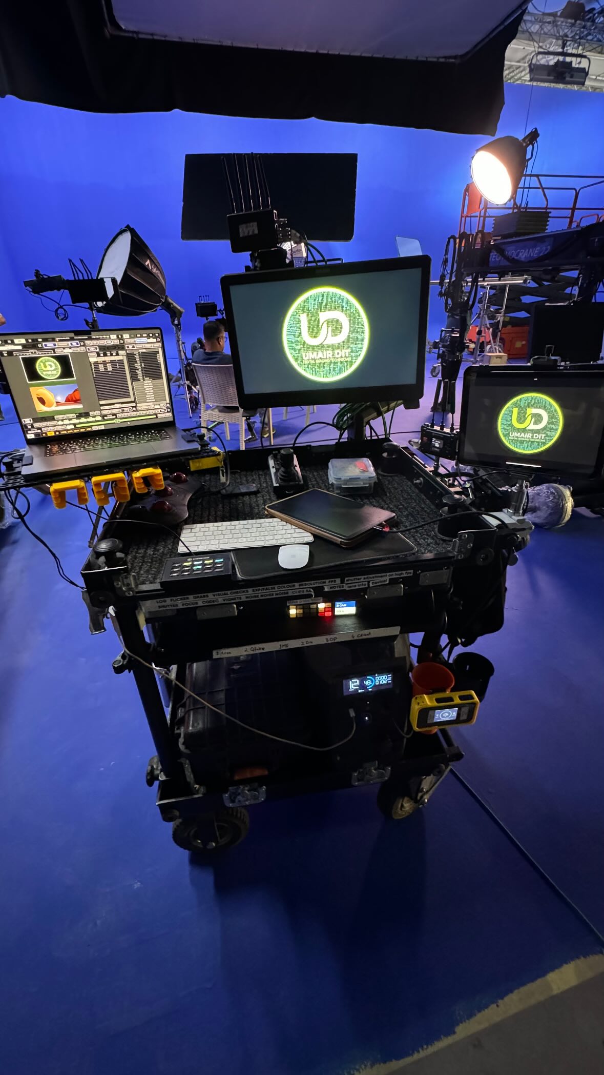 Umair's DIT cart on a blue-lit stage with the UD logo on the monitor