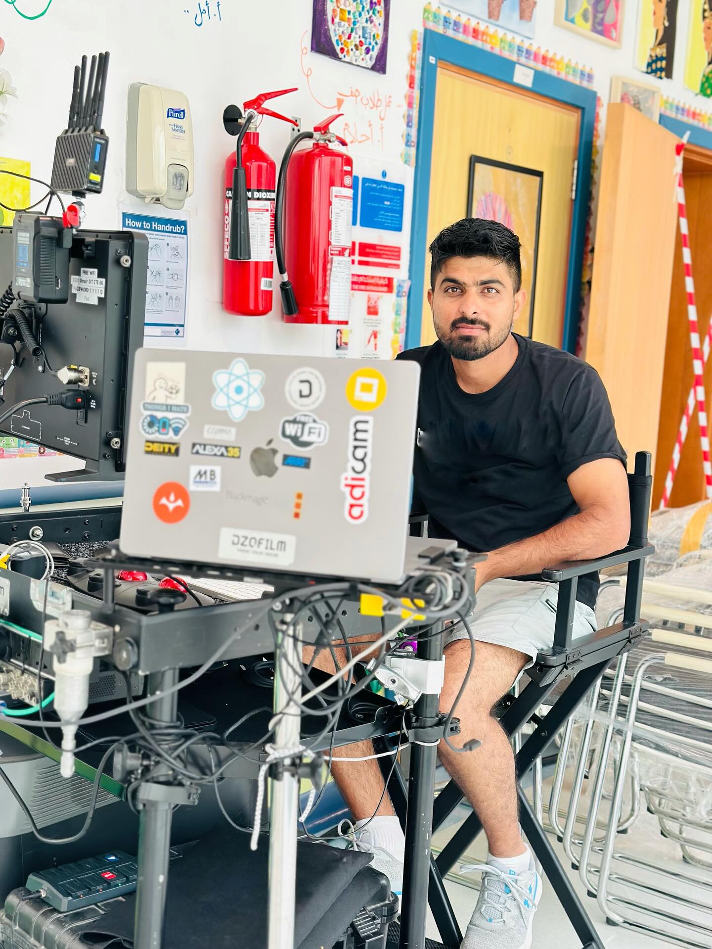 Umair sitting at his cart in a school classroom